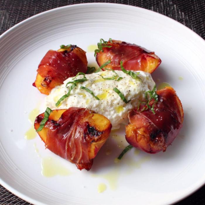 Grilled prosciutto wrapped peaches with burrata and basil