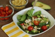 Spinach salad with chicken avocado and goat cheese