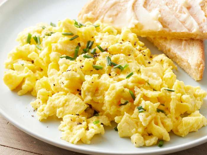 Creamy cheesy scrambled eggs with basil