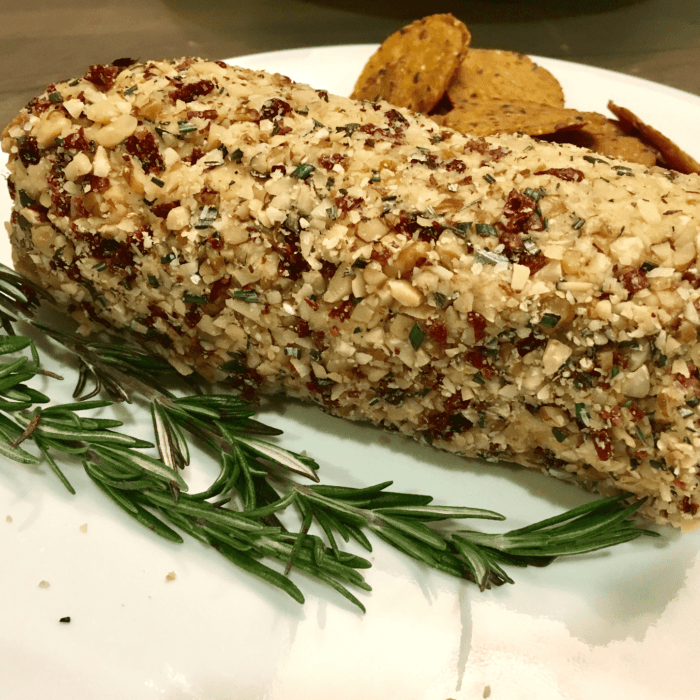 Vegan cashew cheese rolled in cranberries and nuts