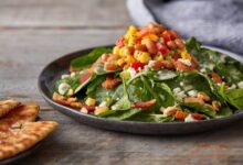 Colorful kale and spinach salad and homemade dressing