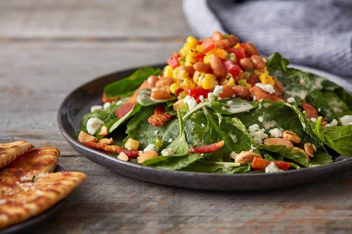 Colorful kale and spinach salad and homemade dressing