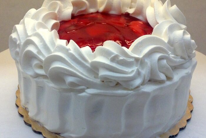 Carry cake with strawberries and whipped cream