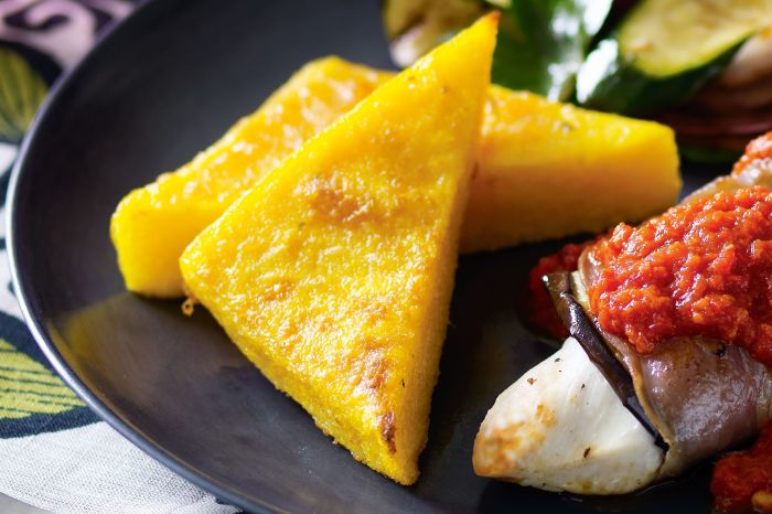 Baked polenta with fresh tomatoes and parmesan