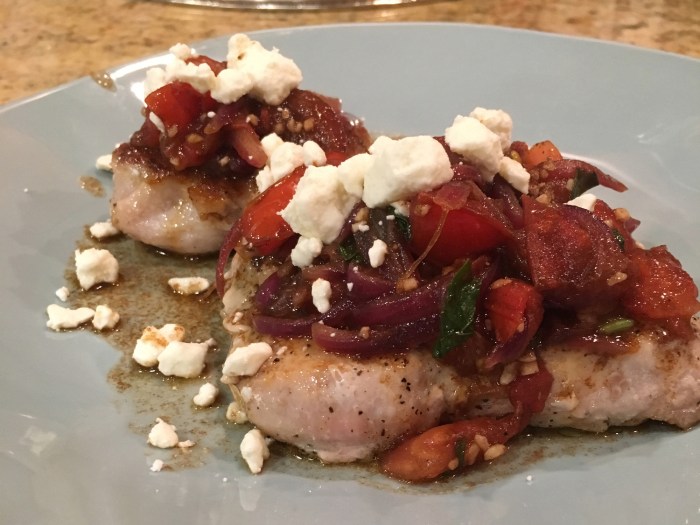 Pork chops with fresh tomato onion garlic and feta