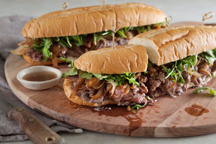 Dripping roast beef sandwiches with melted provolone